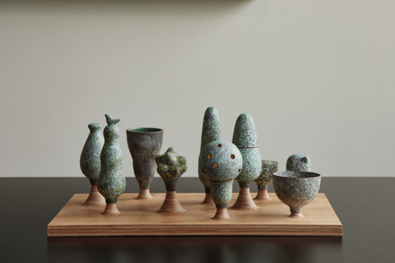 ten ceramic objects on wooden tray