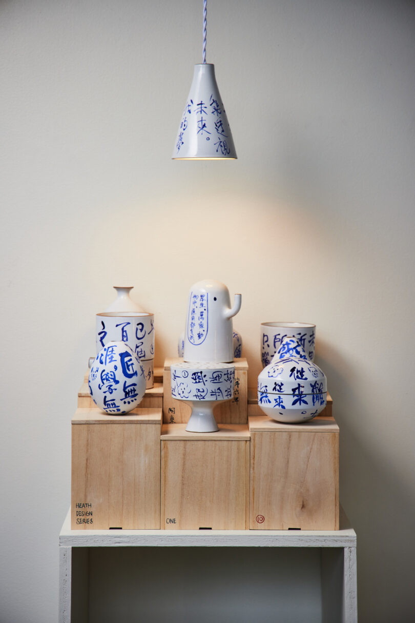ten white and blue ceramic objects on wooden stand