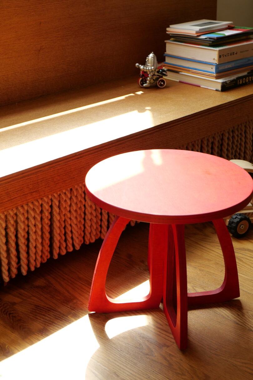 red table next to wooden bench