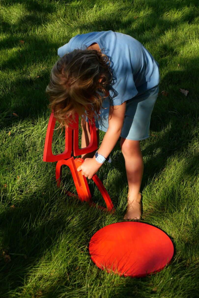 kid assembling a red stool