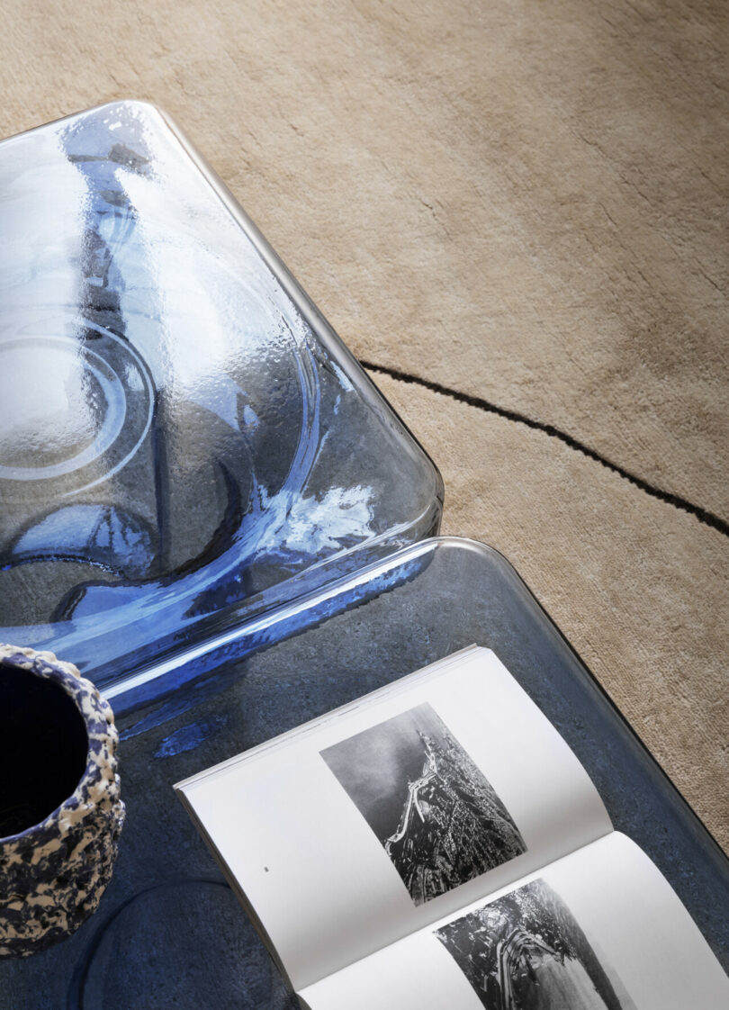 book on blue colored glass side table