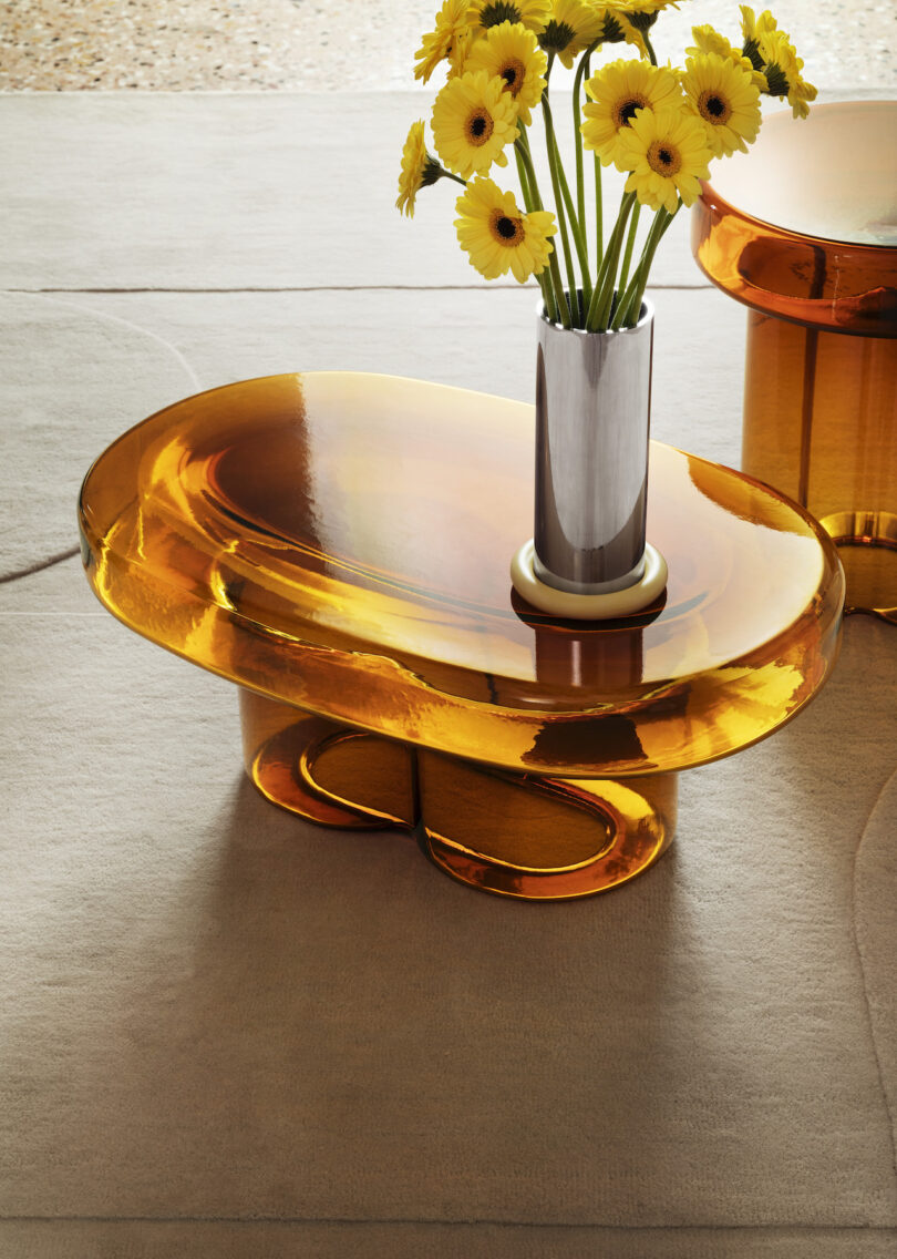 vase of flowers on an orange glass side table