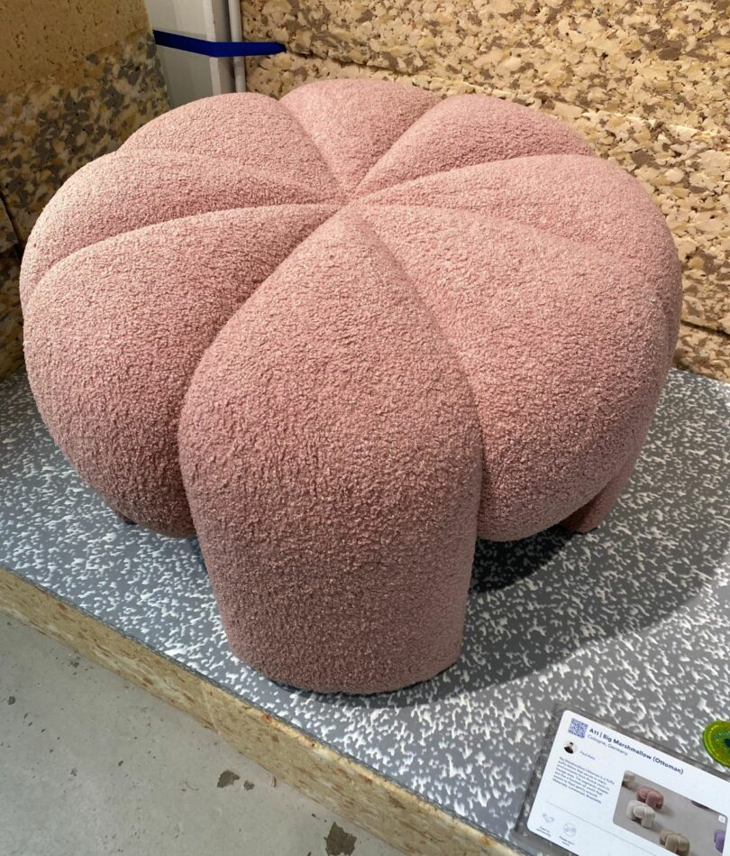 A pink ottoman with segmented sections