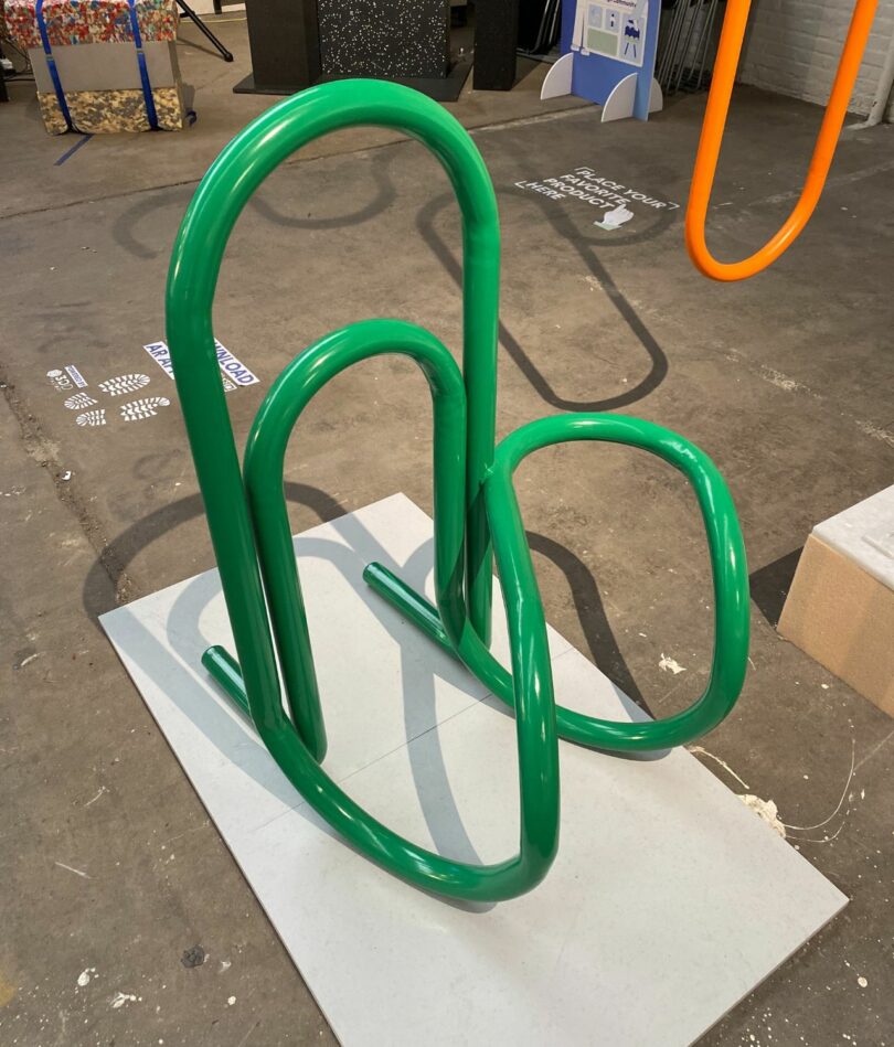 A green sculpture that looks a bit like a paperclip