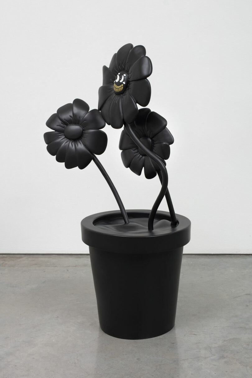 oversized sculpture of three black flowers in black pot