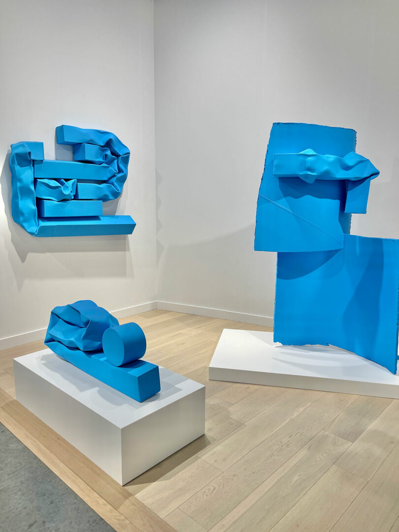 GALLERY VIEW OF three abstract blue sculptures