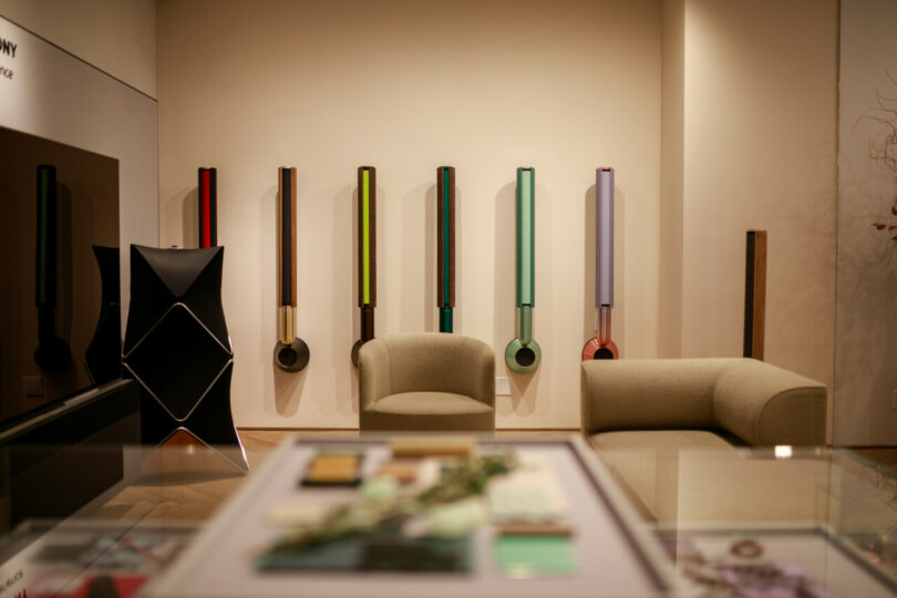 Wall of mounted tubular speakers in a variety of colors.