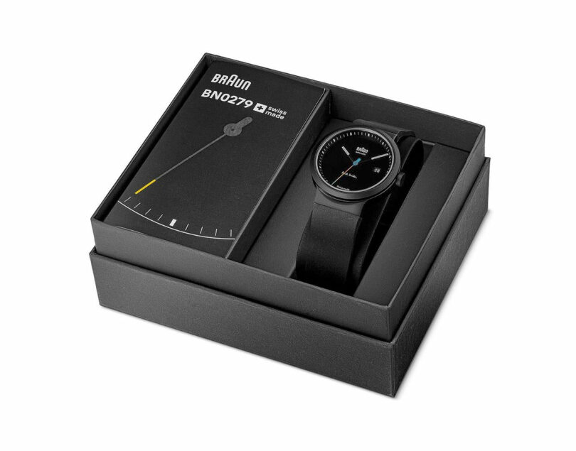 black minimalist watch with stripe second hand in box