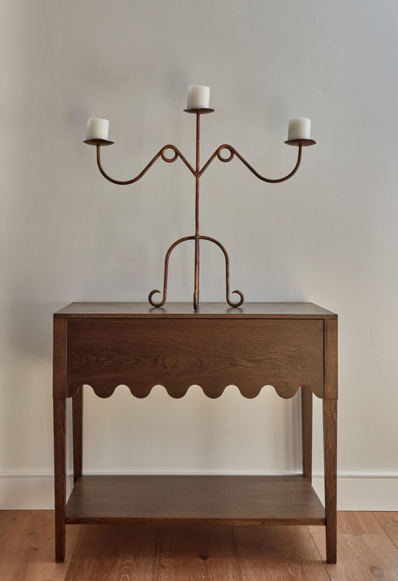 dark wood nightstand holding a candelabra