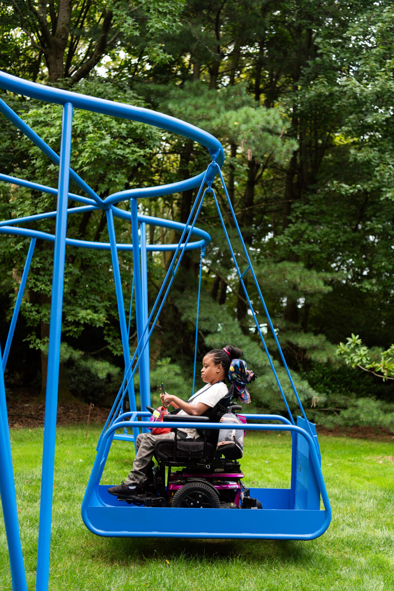 public installation of electric blue accessible swings