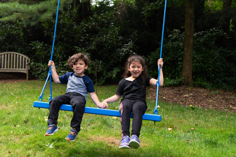 public installation of electric blue accessible swings