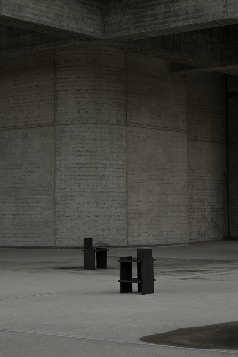 Black chairs in an open concrete space