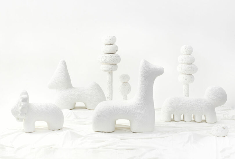 assembled group of white ceramic abstract animal sculptures