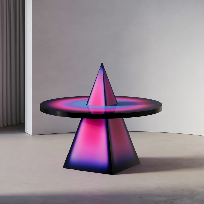 set view of unique table with pyramid shaped base piercing through circular tabletop in bold pink and purple colors