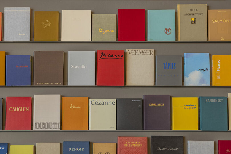 shelves of colorful coffee table books covers forward