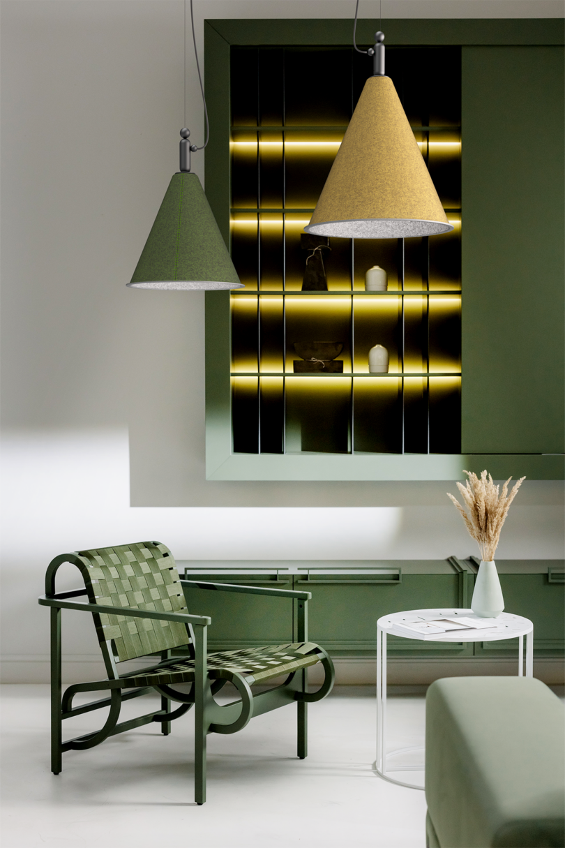 two green and ochre cone-shaped lamps suspended about a styled living space