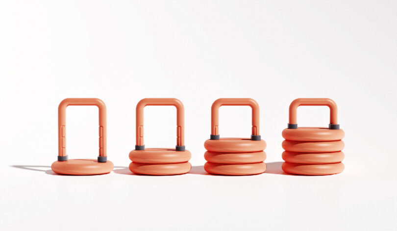 Lift stackable weight kettlebell in red-orange against similar colored background shown in a line up of four different weight loads ranging from one weight plate loaded to all four.