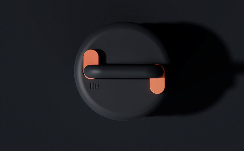 Overhead top view of Lift stackable weight kettlebell in black with orange lock mechanism details.
