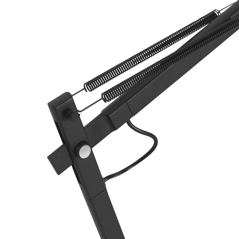 Close do mecanismo de articulação do braço de mola da lâmpada de mesa com base preta