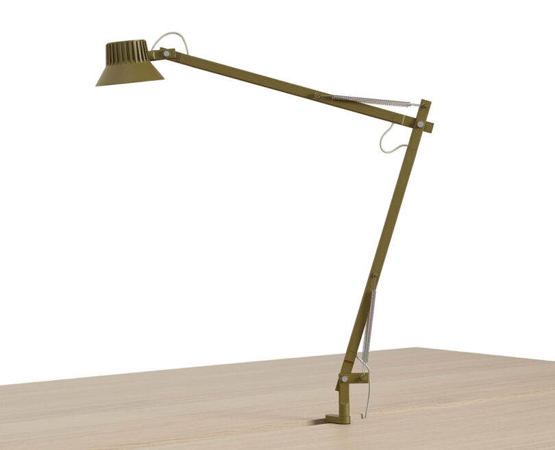 Olive green and brown pin mounted desk lamp with spring arm and small LED light.