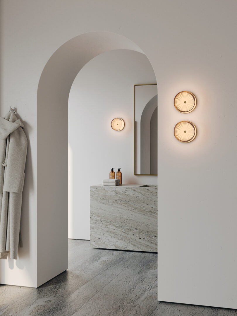 three circular wall sconces in a styled interior space