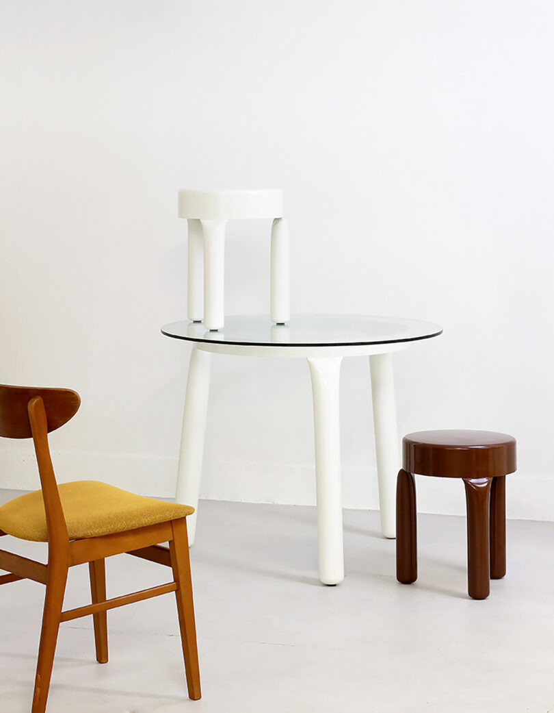 dining chair, two low stools, and a round white table