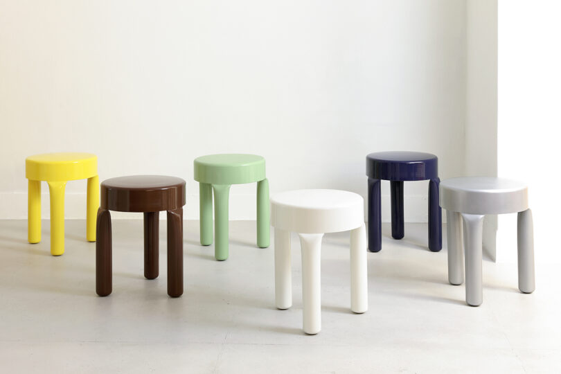 six low stools of various colors