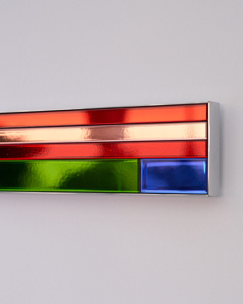 detaili of long horizontal bar with pieces of colored mirror