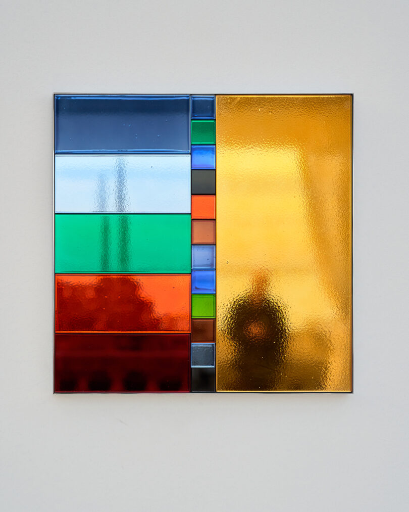 square made up of geometric pieces of colored mirror