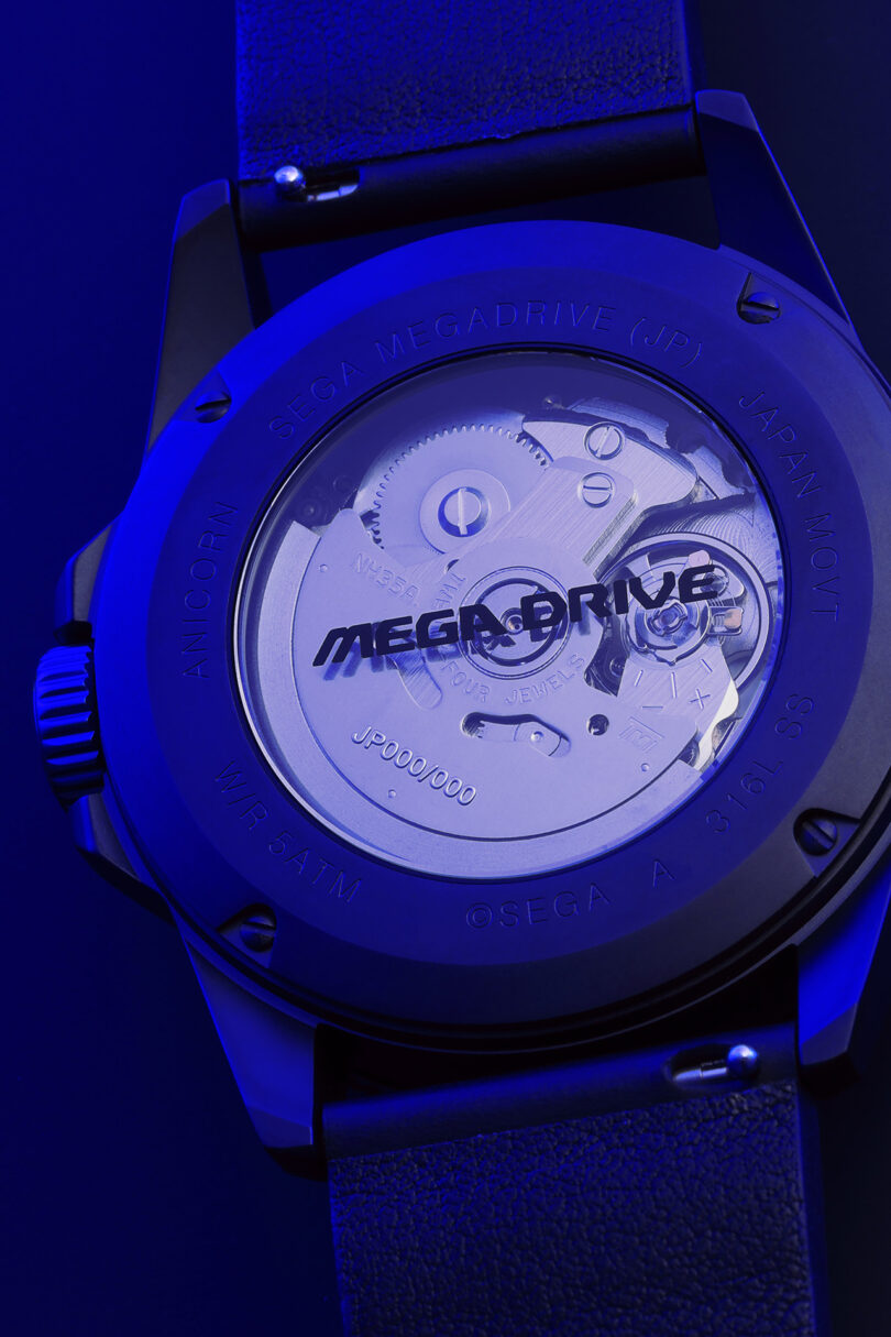 See-through caseback detail of the SEGA x Anicorn Mega Drive/Genesis Watch with "Mega-Drive" logo printed across its glass window.