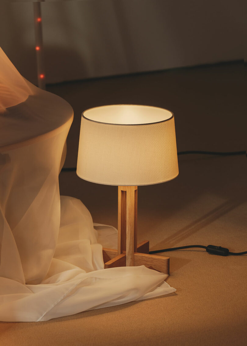 A wooden table lamp on the floor