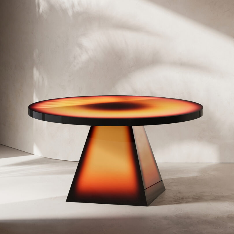 table with pyramid-shaped base and round top with radial color