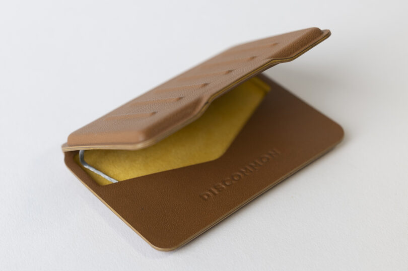 slim brown wallet with yellow interior