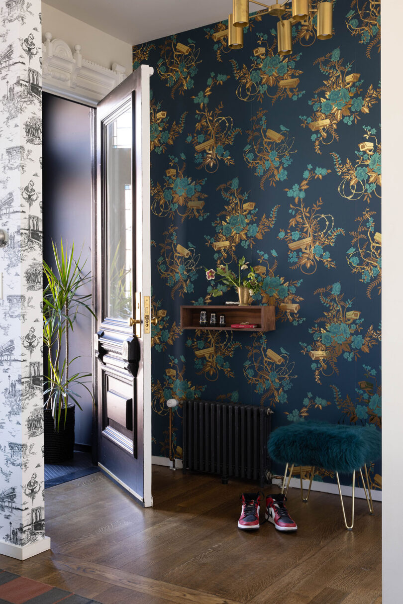 styled entryway decorated with bold floral wallpaper