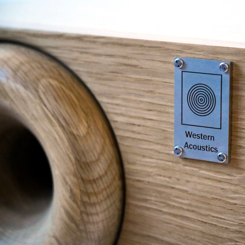 Detail of the metal Western Acoustics metal emblem adorning the Type 2 bookshelf speakers with a 2-tone speaker.