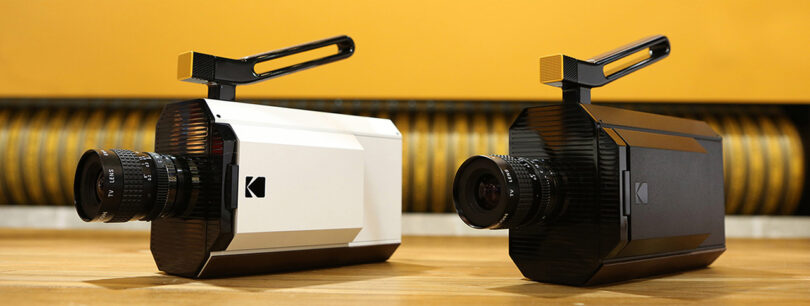 Two Kodak Super 8 Camera shown side by side, one with white case, the other in all-black.