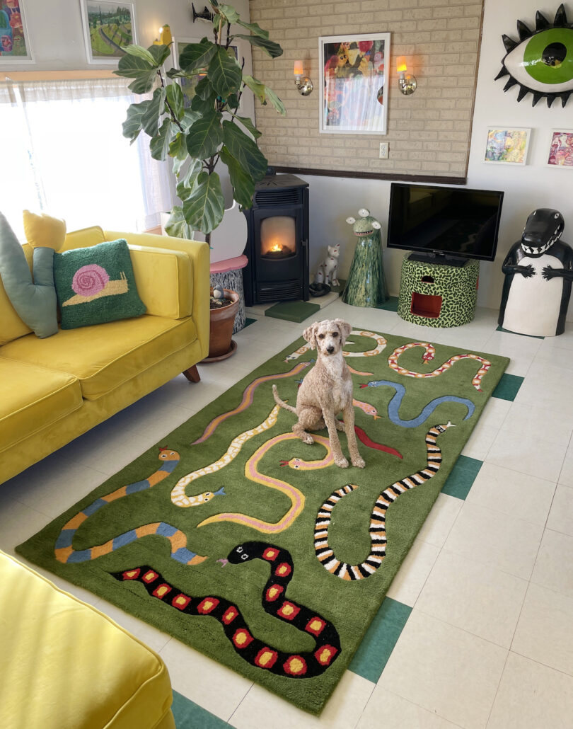 dog on green rug with snakes in living room