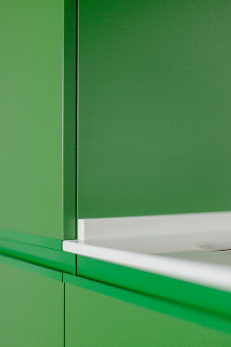 closeup angled view of bright green kitchen cabinets