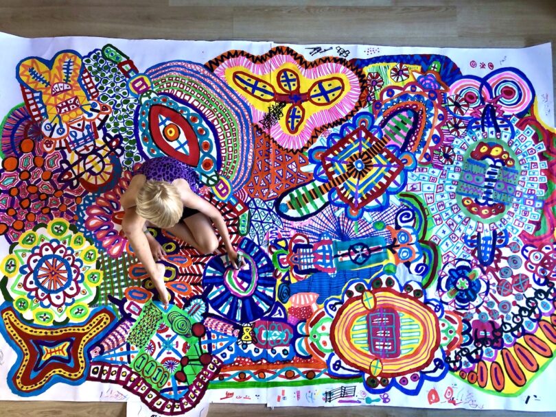child creating a ample statement drawing