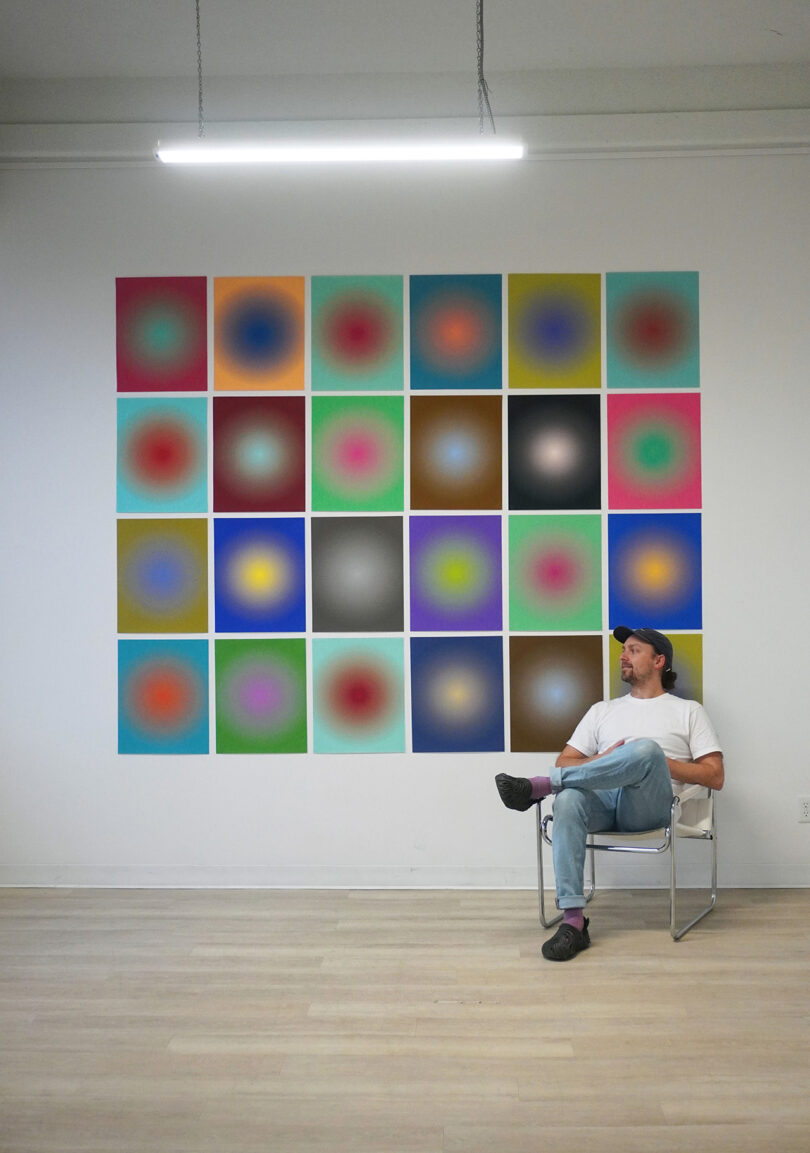 wall grid of framed gradient prints with a man in a chair