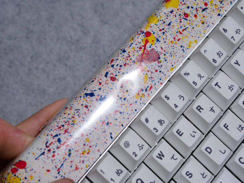 Detail of jawbreaker candy style splattered multicolor paint mechanical keyboard finish.