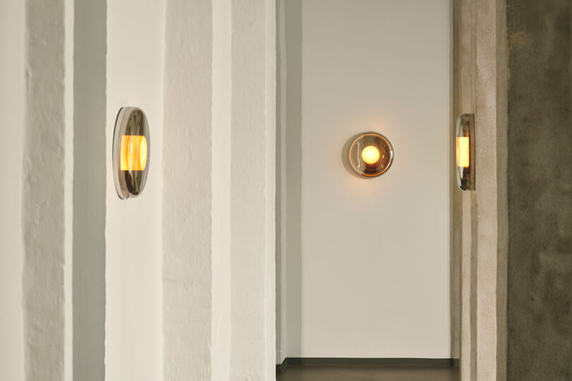 three mounted mirrored wall lights