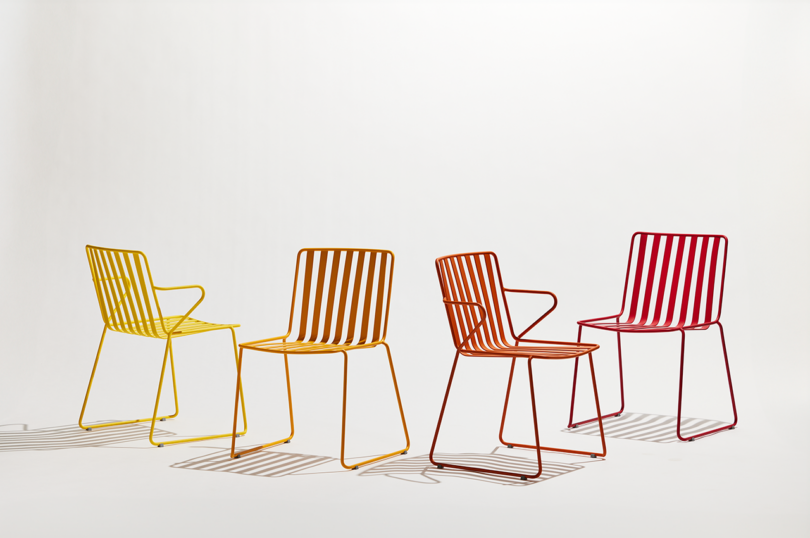 four colorful slatted metal outdoor chairs