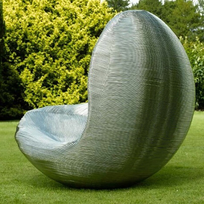 outdoor art installation of a silver bean-shaped sculpture