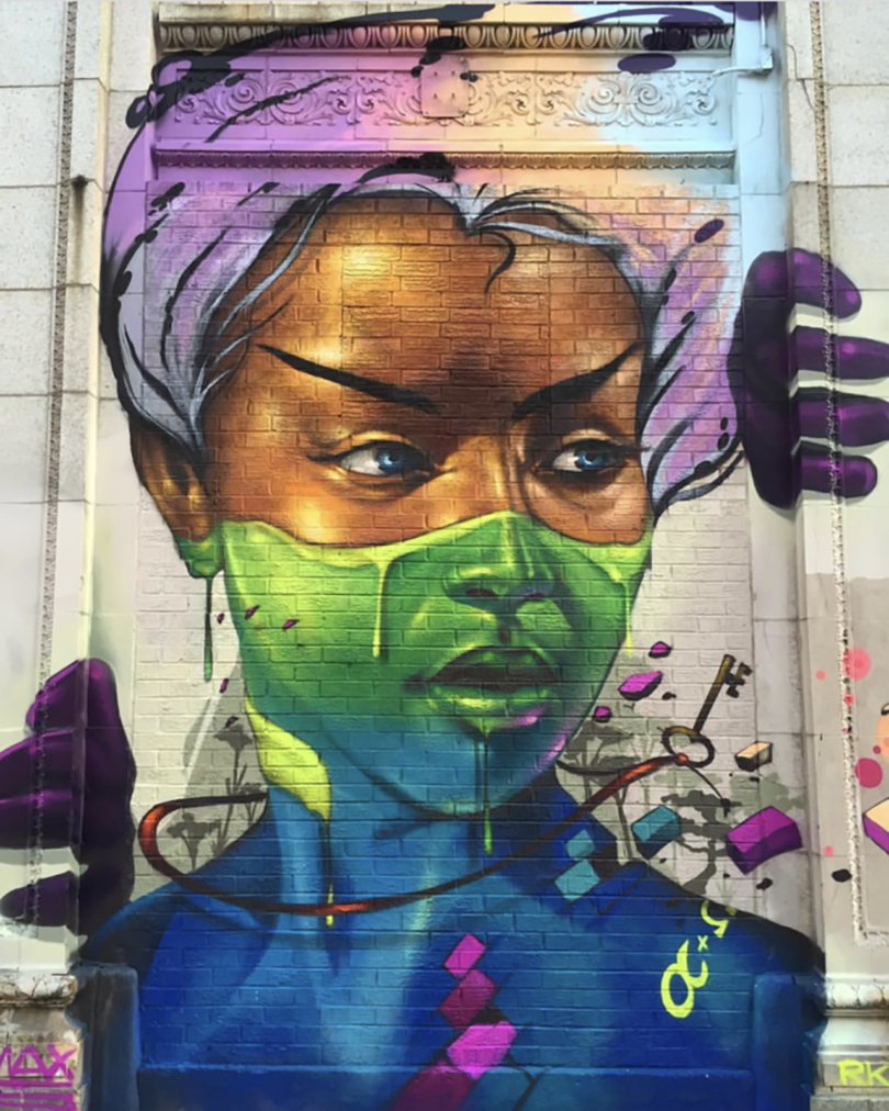 large outdoor mural of a brown-skinned girl's face