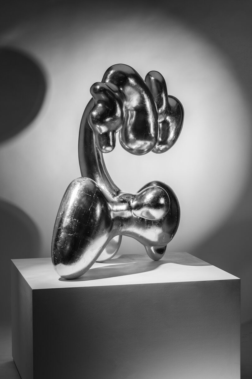 abstract silver sculpture on a pedestal