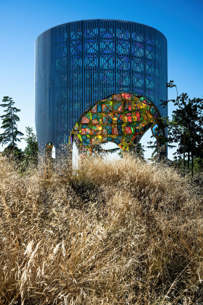 cylindrical public art sculpture with aluminum pipes and dichroic acrylic