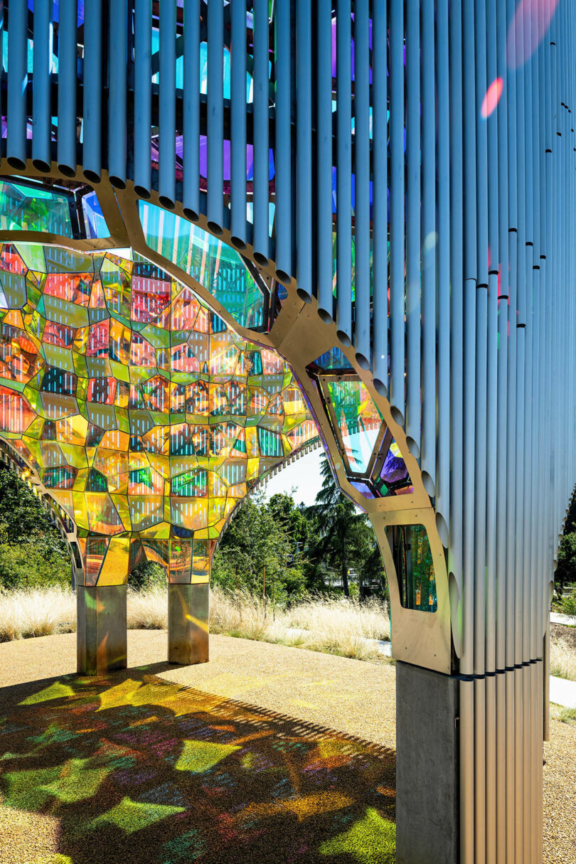 cylindrical public art sculpture with aluminum pipes and dichroic acrylic