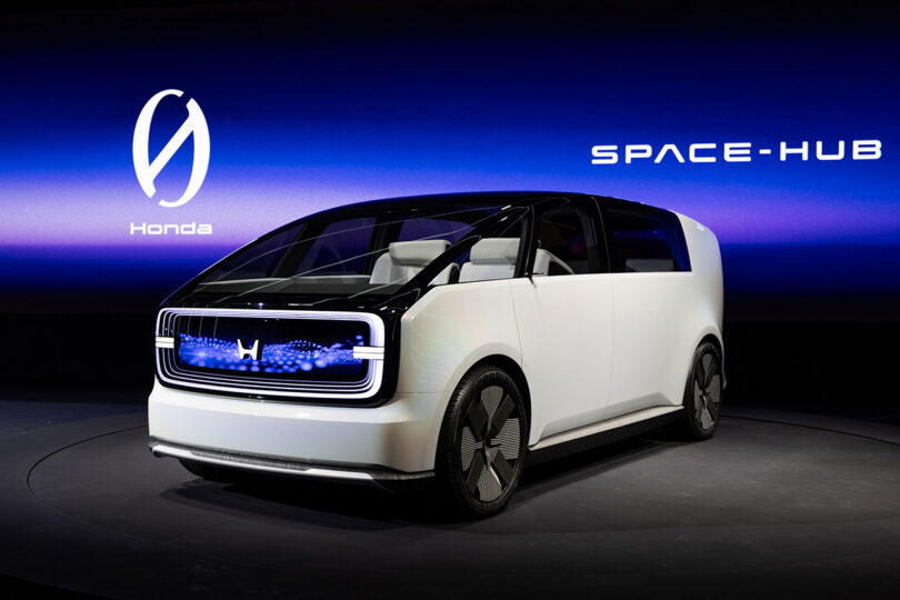 Honda's new Space-Hub minivan concept, one of two new Zero Series vehicles unveiled on stage at CES 2024, with large wide screen showcasing the new Zero Series logo in background.