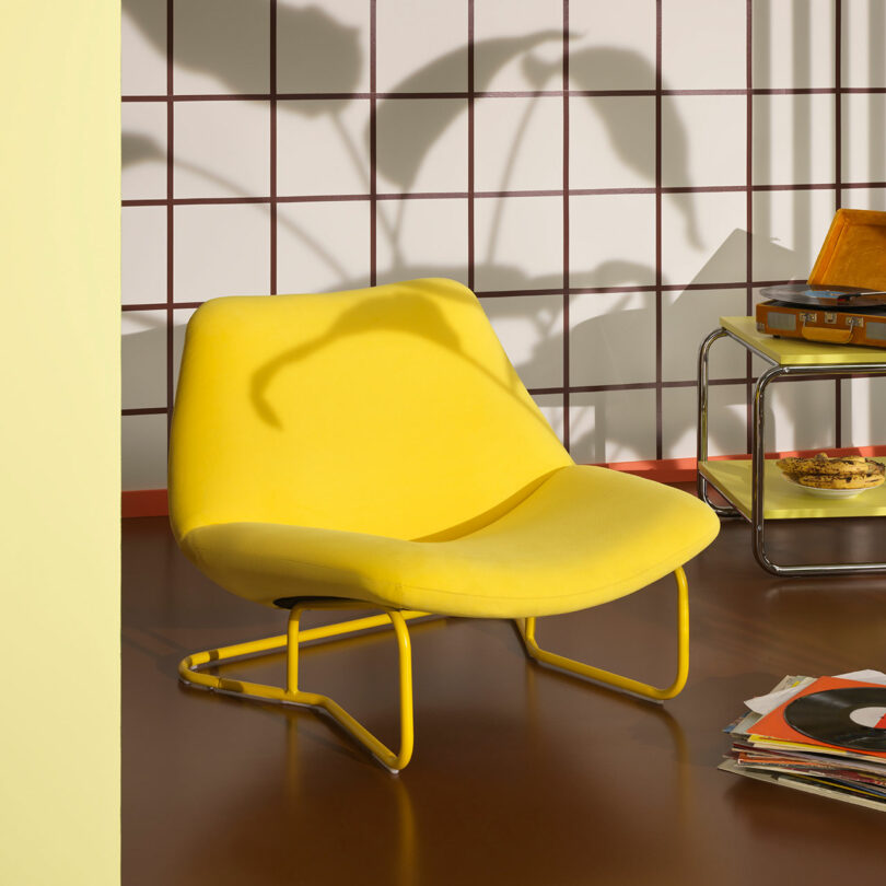 angled view of modern bright yellow upholstered chair
